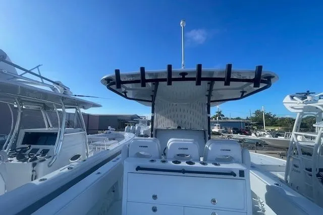 Slide: The Image of 2026 Contender 39 ST boat with sleek design and modern features, docked under clear blue sky. - 22