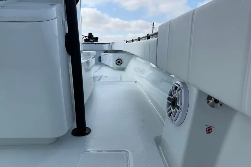Slide: The Image of 2026 Contender 39 ST boat interior with white seating and marine speakers. - 23