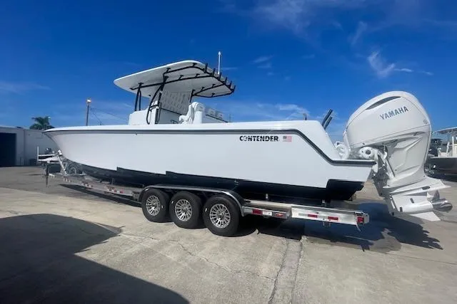 Slide: The Image of 2026 Contender 39 ST boat on trailer with Yamaha engines, parked outdoors. - 3
