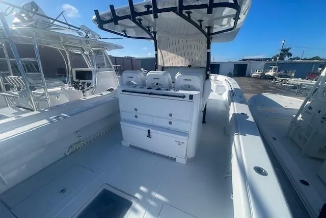 Slide: The Image of 2026 Contender 39 ST boat interior with modern seating and equipment under a clear blue sky. - 5