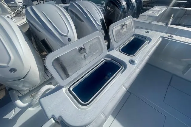 Slide: The Image of 2026 Contender 39 ST boat with open storage compartments and powerful outboard engines. - 7