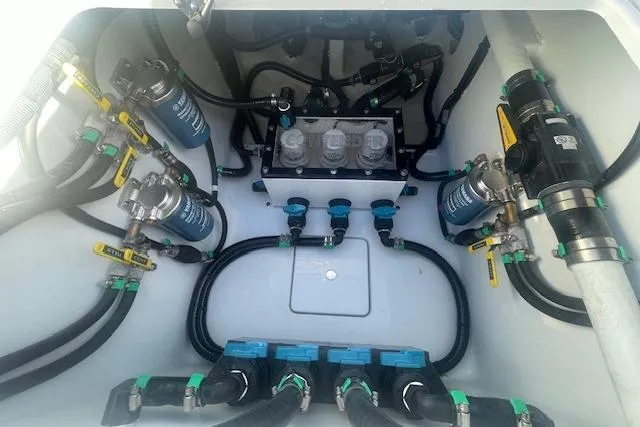 Slide: The Image of Engine compartment of 2026 Contender 39 ST boat, showcasing complex wiring and filtration systems. - 9