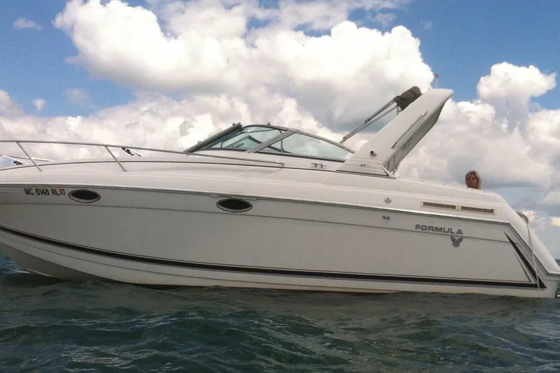 Slide: The Image of 1998 Formula 27 Performance Cruiser on water under cloudy sky. - 1