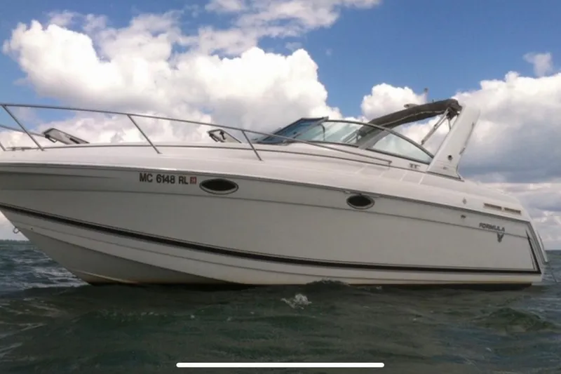 Slide: The Image of 1998 Formula 27 Performance Cruiser on water under cloudy sky. - 3