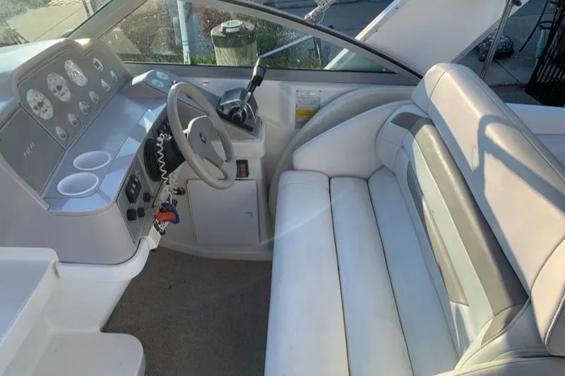 Slide: The Image of 1998 Formula 27 Performance Cruiser cockpit with steering wheel and seating. - 5