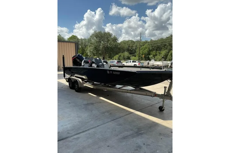Slide: The Image of 2022 Crestliner MX 21 boat on trailer, parked outdoors under a cloudy sky. - 4