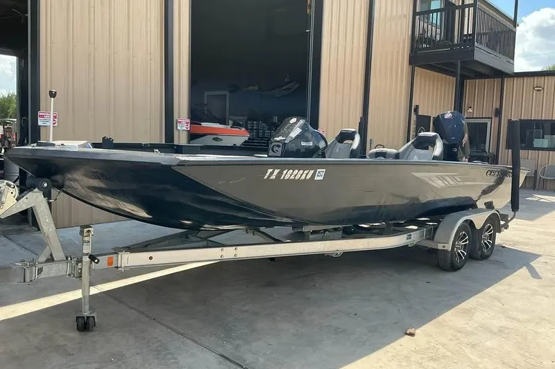 Slide: The Image of 2022 Crestliner MX 21 boat on trailer outside a building. - 6