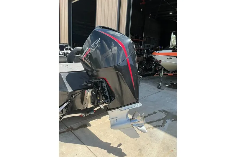 Slide: The Image of 2022 Crestliner MX 21 boat with Mercury 250 outboard motor in a garage setting. - 8