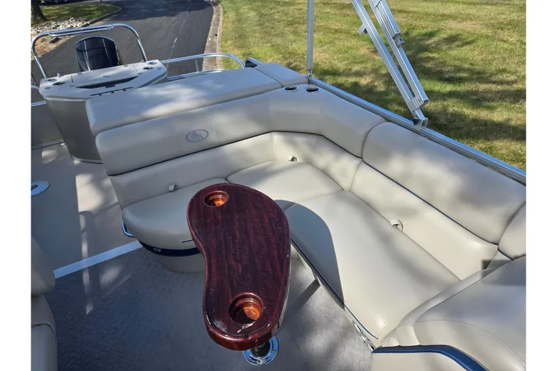 Slide: The Image of 2014 South Bay 522 FCR pontoon boat with beige seating and wooden table. - 12