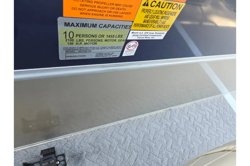 Slide: The Image of 2014 South Bay 522 FCR capacity label, maximum 10 persons or 1455 lbs, 150 HP motor. - 13