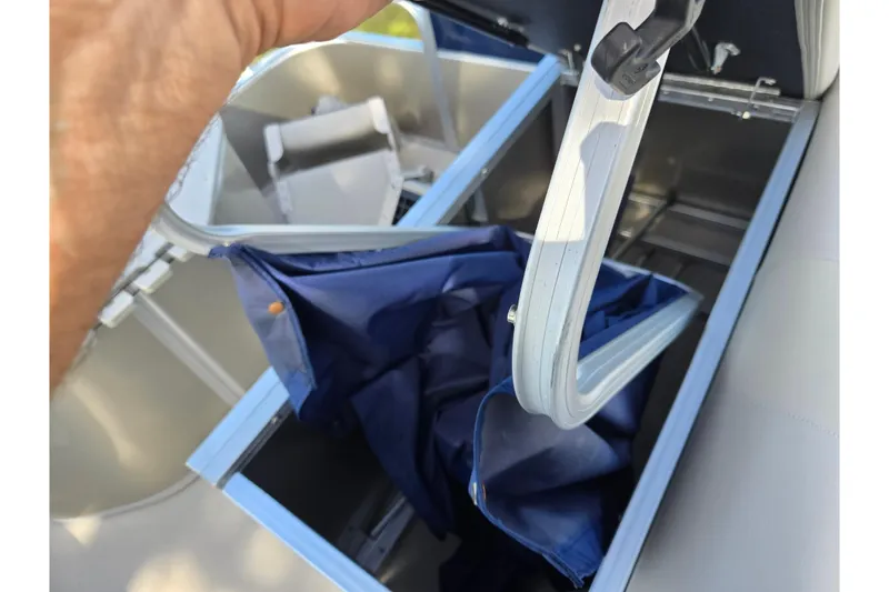 Slide: The Image of 2014 South Bay 522 FCR boat storage compartment with blue fabric liner. - 15