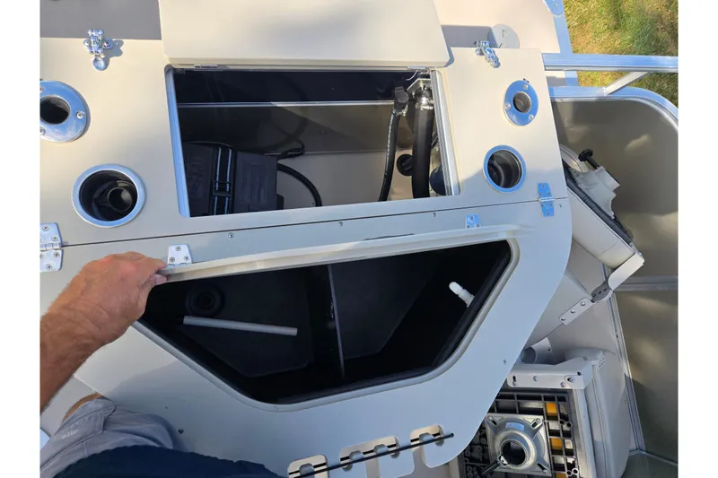 Slide: The Image of Open storage compartment on a 2014 South Bay 522 FCR boat, showing interior details. - 17