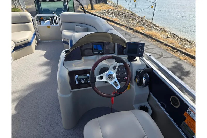 Slide: The Image of 2014 South Bay 522 FCR boat interior with steering wheel and control panel. - 22