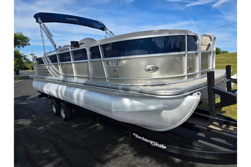 Slide: The Image of 2014 South Bay 522 FCR pontoon boat on trailer, parked outdoors under blue sky. - 5