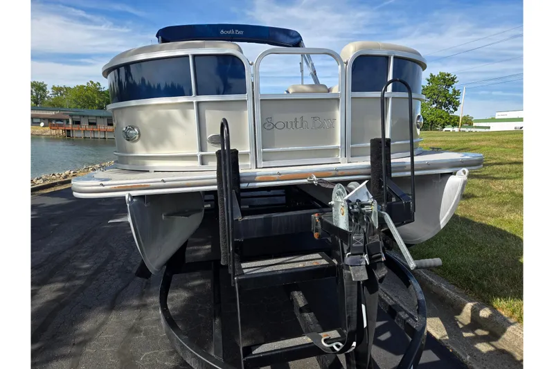 Slide: The Image of 2014 South Bay 522 FCR pontoon boat on trailer, parked near a lake. - 6