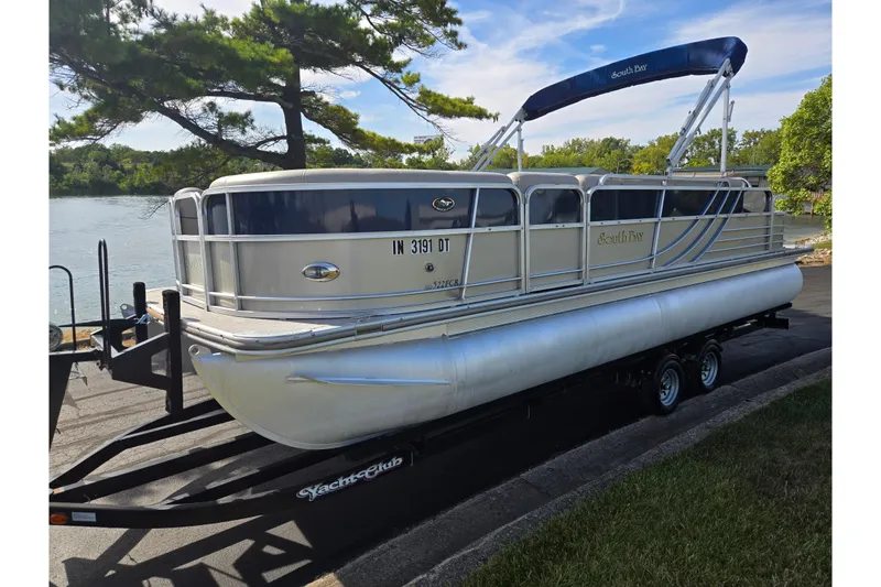 Slide: The Image of 2014 South Bay 522 FCR pontoon boat on trailer by a scenic lake. - 8