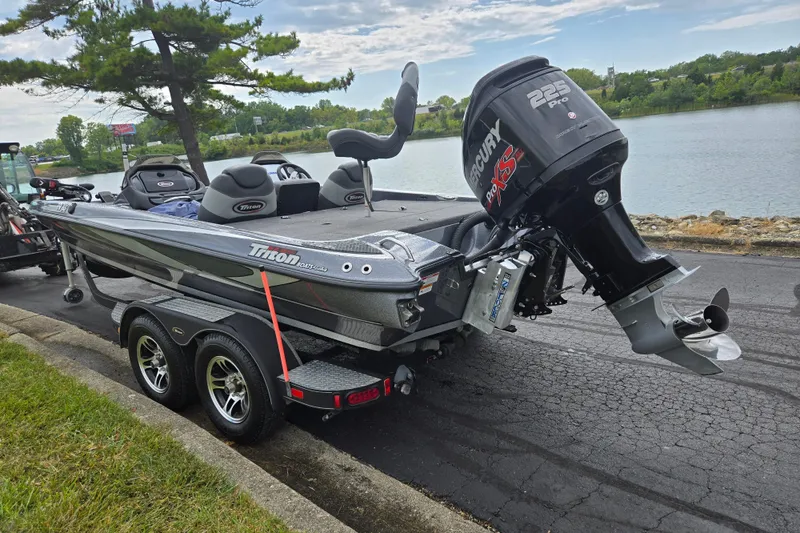 Slide: The Image of 2014 Triton 19XS boat with Mercury 225 Pro XS engine on trailer by lake. - 1