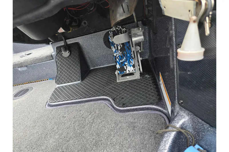 Slide: The Image of Interior view of a 2014 Triton 19XS boat showing foot pedal and controls. - 16