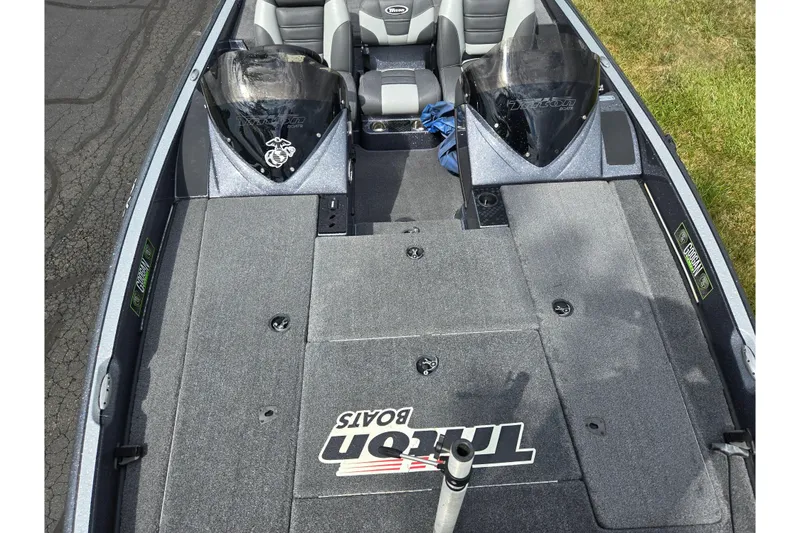Slide: The Image of 2014 Triton 19XS boat interior with seating and storage compartments. - 20