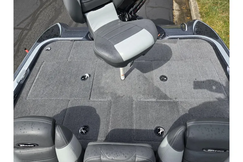 Slide: The Image of 2014 Triton 19XS boat interior with gray seating and carpeted deck. - 23