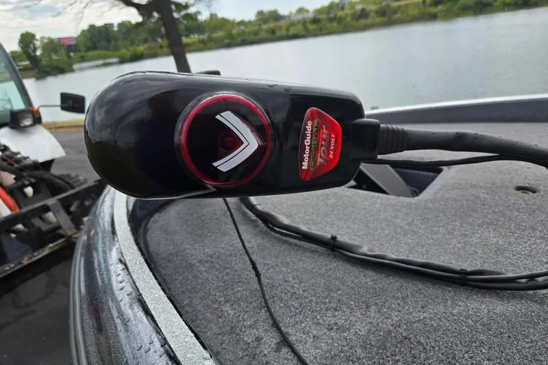 Slide: The Image of Triton 19XS 2014 boat with MotorGuide Tour trolling motor by a lake. - 9