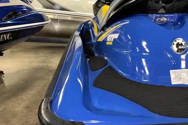 Slide: The Image of 2006 Sea-Doo GTI SE jet ski in blue, parked indoors, showcasing sleek design. - 10