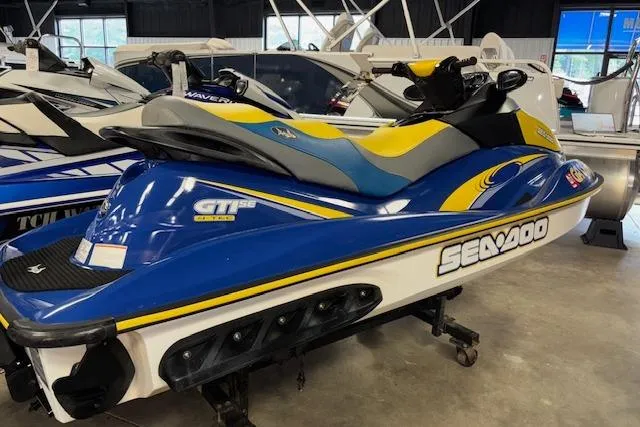 Slide: The Image of 2006 Sea-Doo GTI SE jet ski in blue and yellow, displayed indoors. - 4
