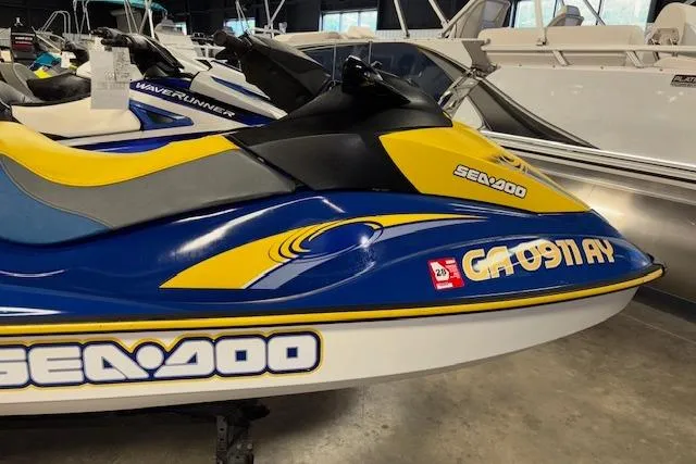 Slide: The Image of 2006 Sea-Doo GTI SE jet ski in blue and yellow, displayed indoors. - 6
