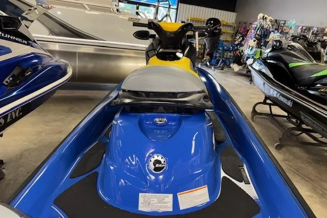 Slide: The Image of 2006 Sea-Doo GTI SE jet ski in showroom, blue and yellow design. - 9