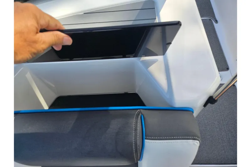 Slide: The Image of 2020 Yamaha AR210 boat storage compartment with open lid and cushioned seating. - 14