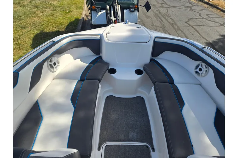 Slide: The Image of 2020 Yamaha AR210 boat interior with cushioned seating and cup holders. - 20
