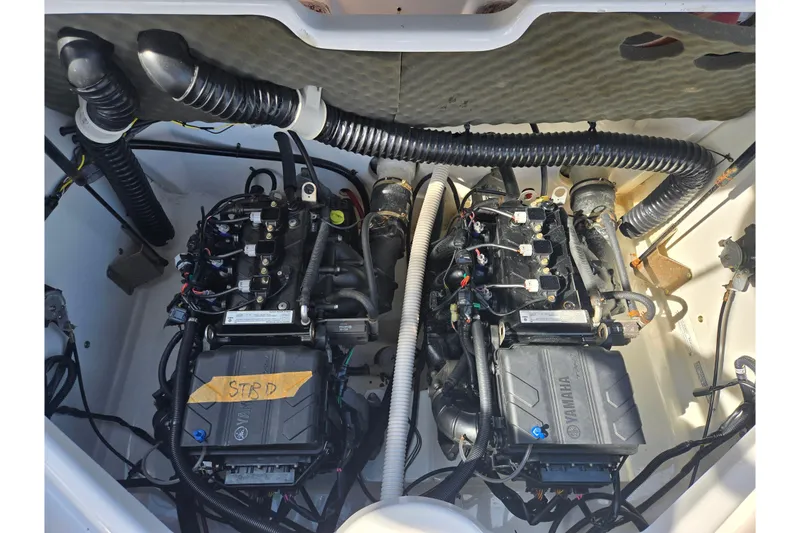 Slide: The Image of 2020 Yamaha AR210 boat engine compartment with dual engines and wiring. - 27