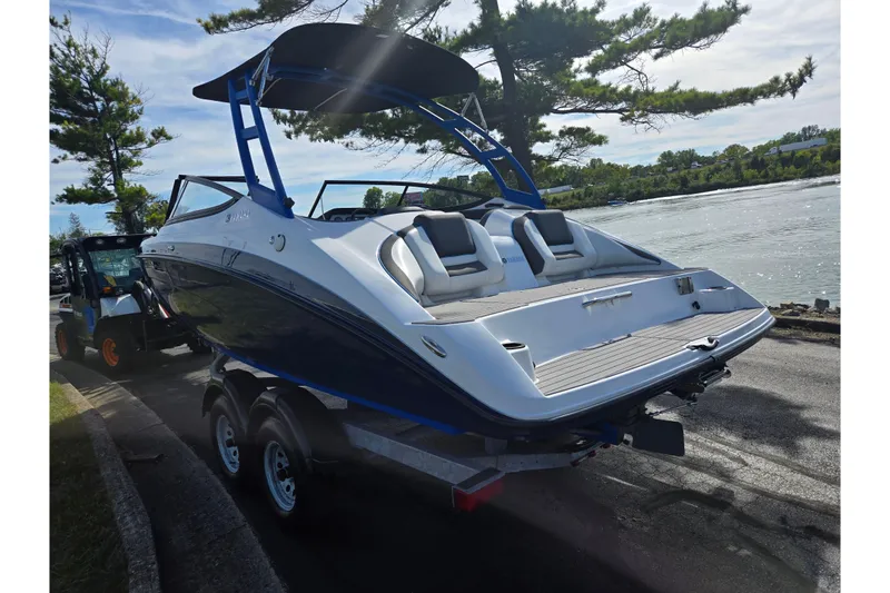Slide: The Image of 2020 Yamaha Boats AR210 on trailer by a scenic waterfront. - 3