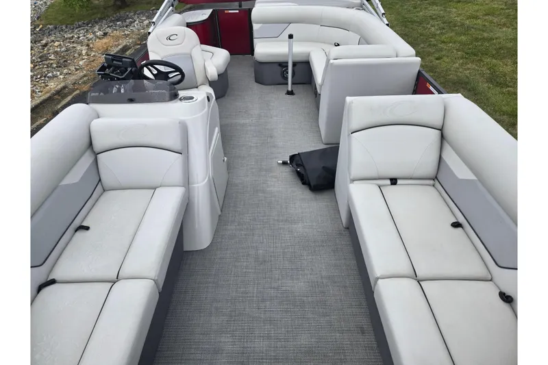 Slide: The Image of 2022 Crest Classic LX 220 pontoon boat interior with spacious seating and modern helm. - 11