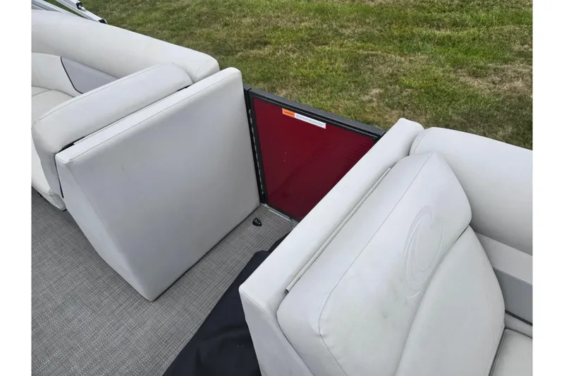 Slide: The Image of 2022 Crest Classic LX 220 boat interior with white seating and red panel. - 12