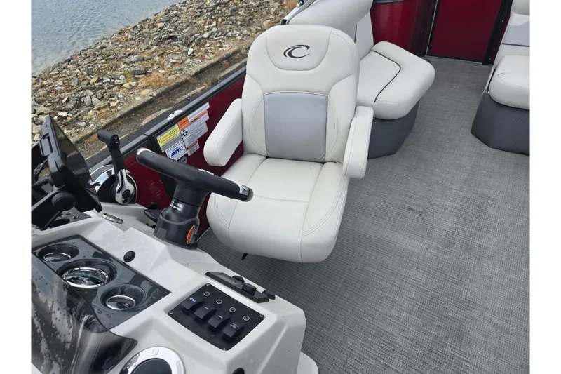 Slide: The Image of 2022 Crest Classic LX 220 boat interior with steering console and seating. - 13