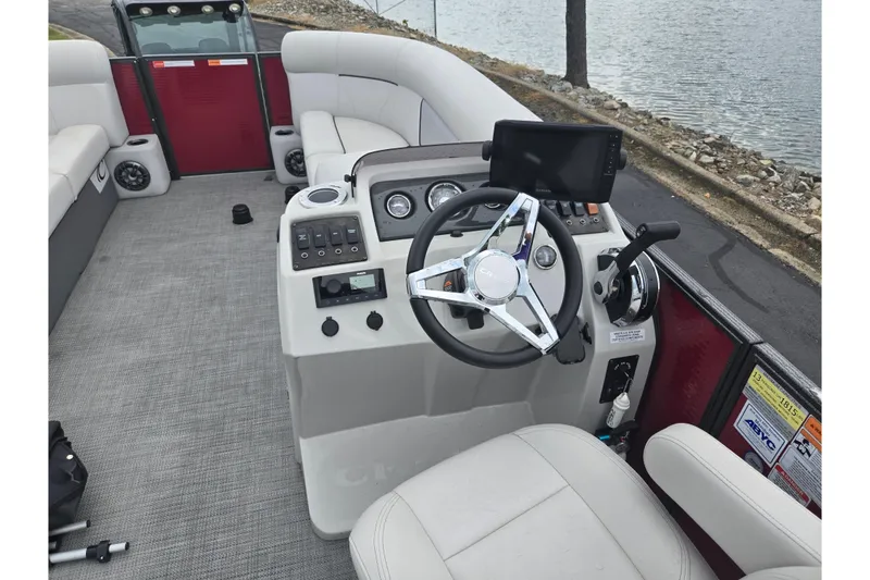 Slide: The Image of 2022 Crest Classic LX 220 boat interior with steering wheel and control panel. - 21