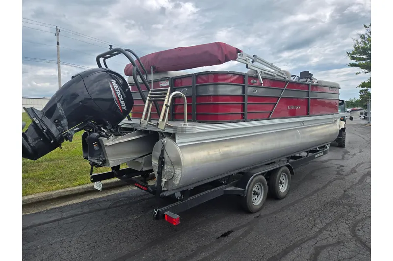 Slide: The Image of 2022 Crest Classic LX 220 pontoon boat on trailer with Mercury outboard motor. - 3