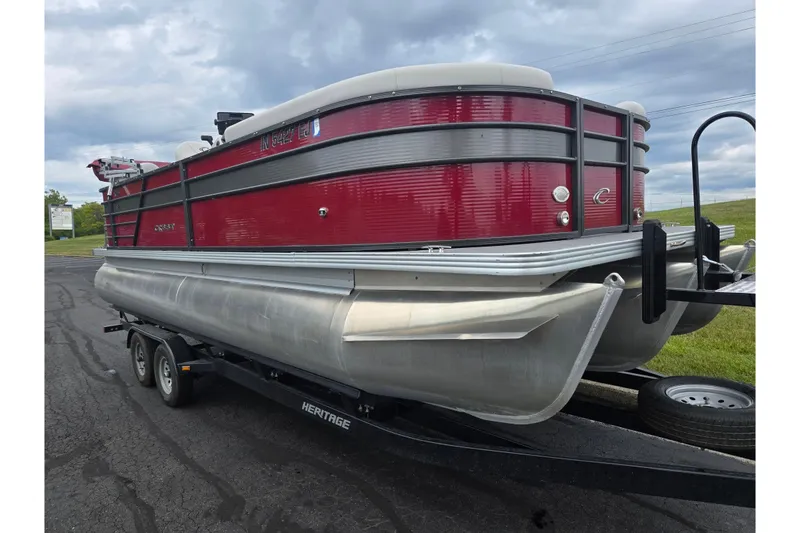 Slide: The Image of 2022 Crest Classic LX 220 pontoon boat on trailer, red and silver design. - 5
