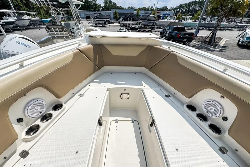 Slide: The Image of 2018 Sailfish 275 DC boat interior with seating, speakers, and cup holders. - 13