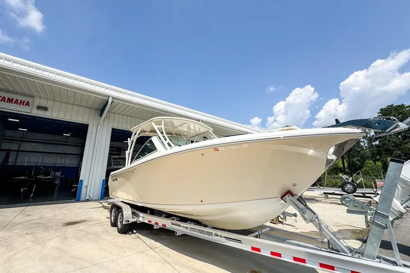Slide: The Image of 2018 Sailfish 275 DC boat on trailer outside Yamaha service center. - 2