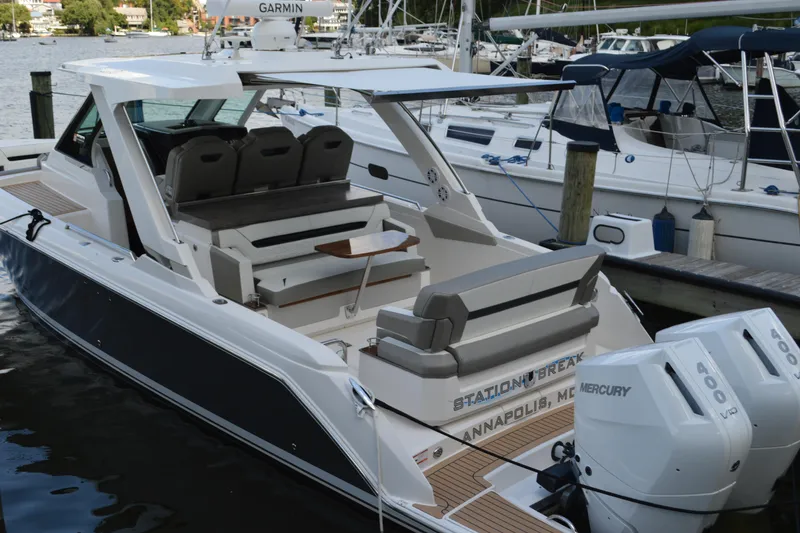 Slide: The Image of 2024 Tiara Yachts 34 LS docked, featuring dual Mercury engines and spacious seating. - 10