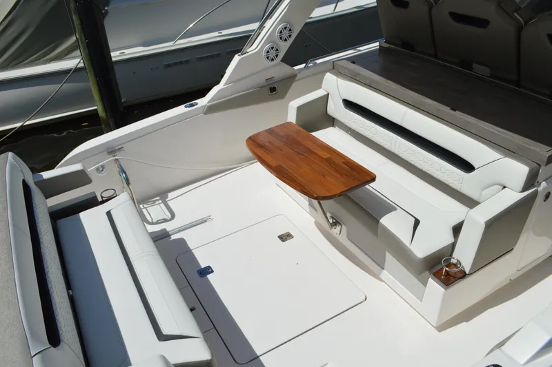 Slide: The Image of 2024 Tiara Yachts 34 LS interior with sleek seating and wooden table. - 15
