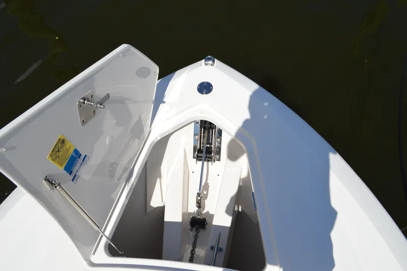 Slide: The Image of 2024 Tiara Yachts 34 LS anchor locker with open hatch, showcasing chain and mechanism. - 27