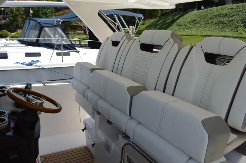 Slide: The Image of 2024 Tiara Yachts 34 LS interior with luxurious seating and wooden steering wheel. - 31