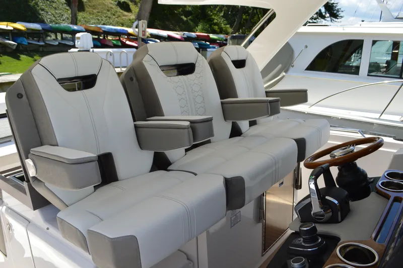 Slide: The Image of Luxury seating and helm of 2024 Tiara Yachts 34 LS, featuring modern design and controls. - 32