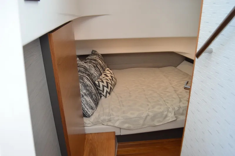Slide: The Image of Cozy cabin interior of 2024 Tiara Yachts 34 LS with stylish bedding and pillows. - 38