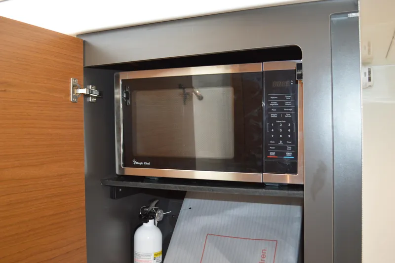 Slide: The Image of Microwave in 2024 Tiara Yachts 34 LS, with fire extinguisher below. - 42