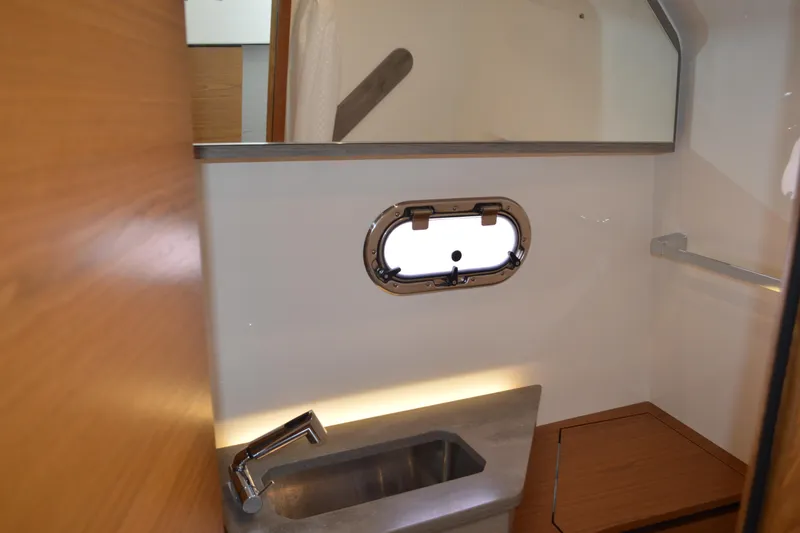 Slide: The Image of 2024 Tiara Yachts 34 LS interior with sink and porthole window. - 44