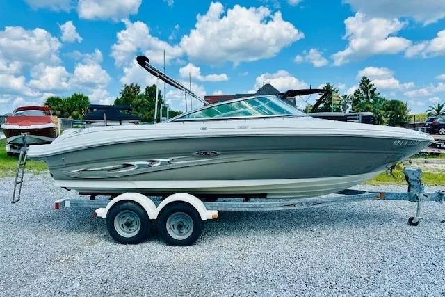 The Image of 2005 Sea Ray 200 Select boat on trailer, parked outdoors under a blue sky. - 0